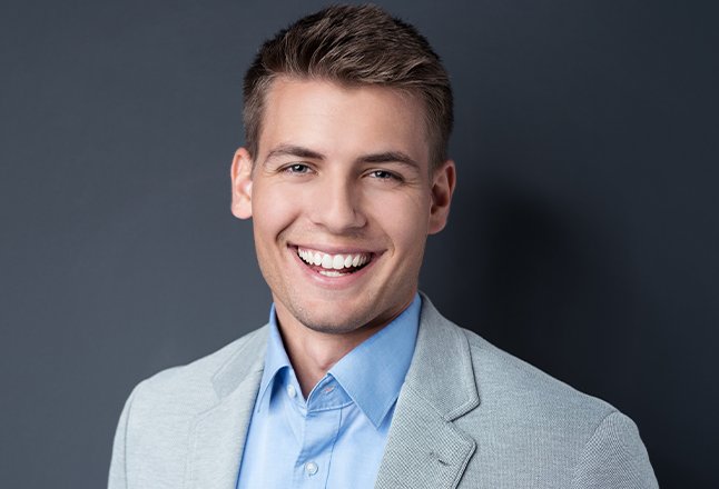 Man sharing smile perfected with porcelain veneers