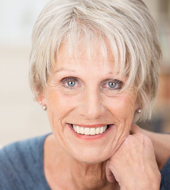 Woman showing her healthy smile with dentures