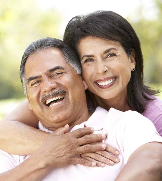 Smiling couple with dental implants in Flower Mound