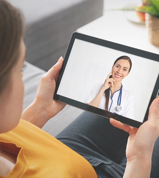 Dentist talking to patient via telehealth app