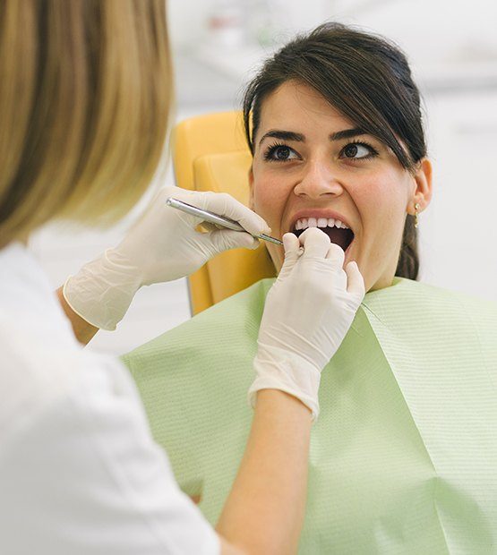 Woman receiving dental exam after tooth extraction