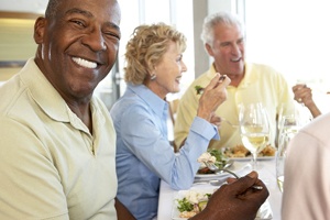 Friends with dental implants in Flower Mound eating a meal together