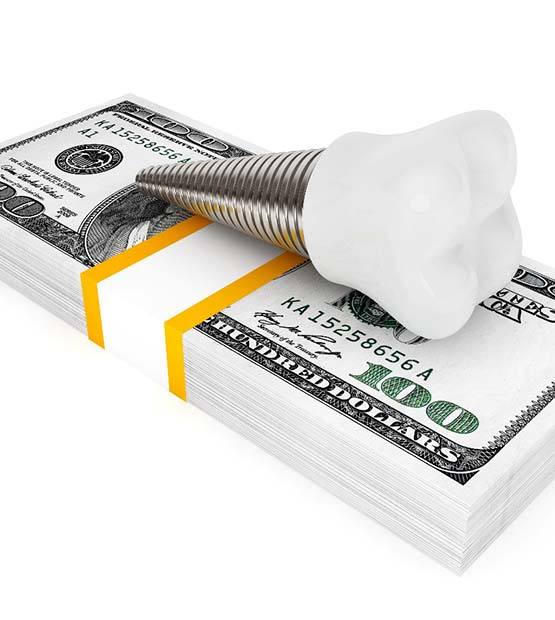 Implant on money representing cost of dental implants in Flower Mound