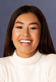Smiling young woman wearing white sweater