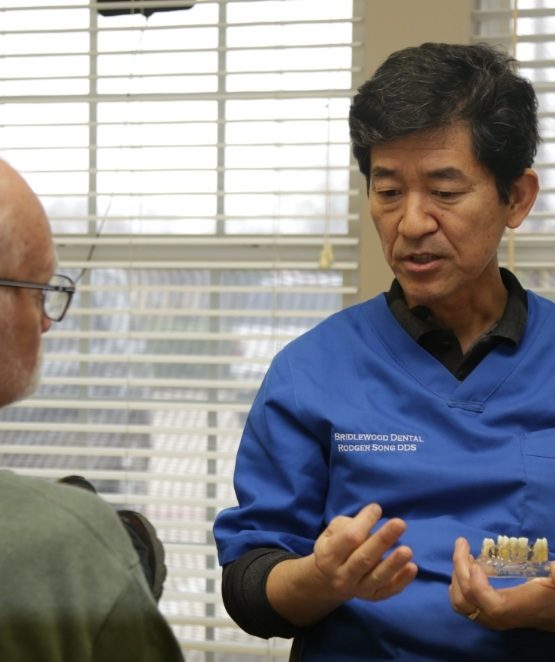 Doctor Song discussing dental implants with patient