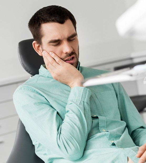 Man in dental office in need of root canal therapy