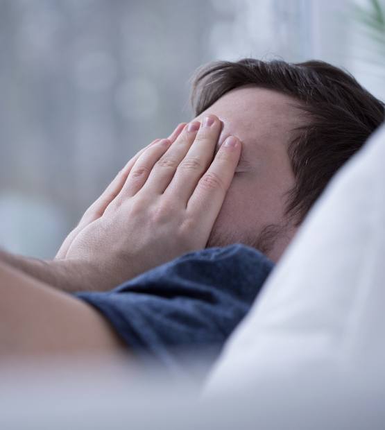 Frustrated man dealing with symptoms of sleep apnea