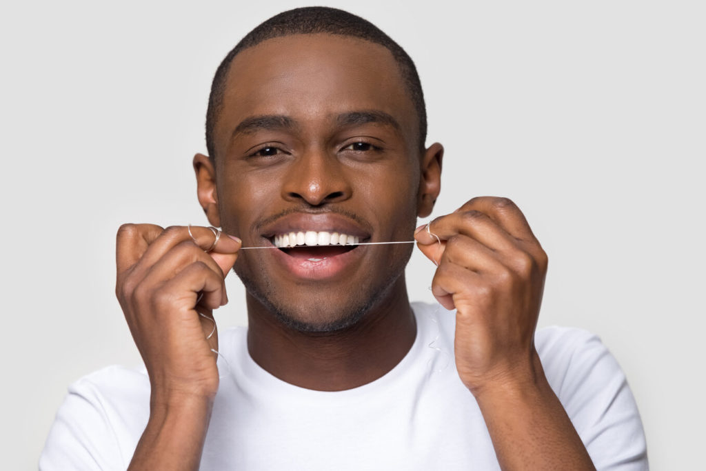 person flossing their teeth
