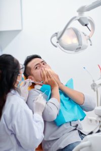 man looking scared at dentist