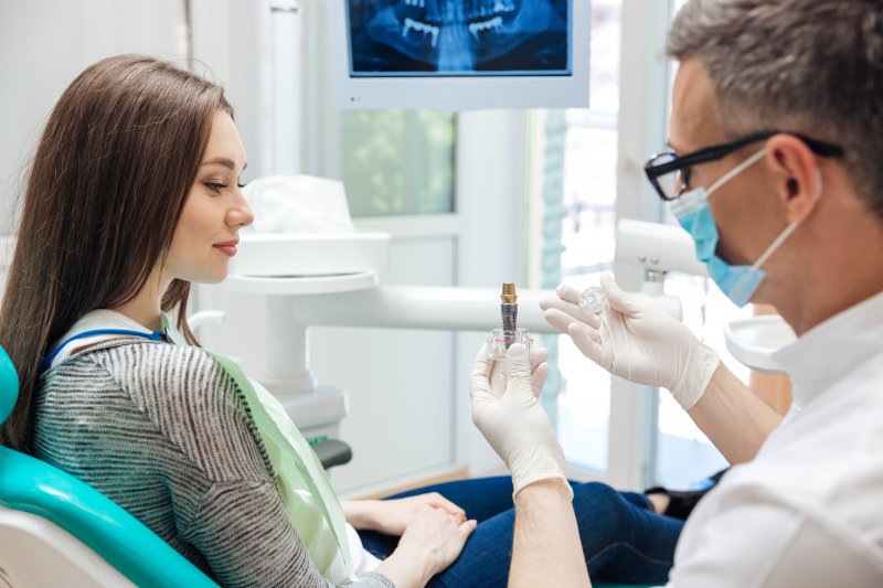 Dentist discussing a patient’s dental implant